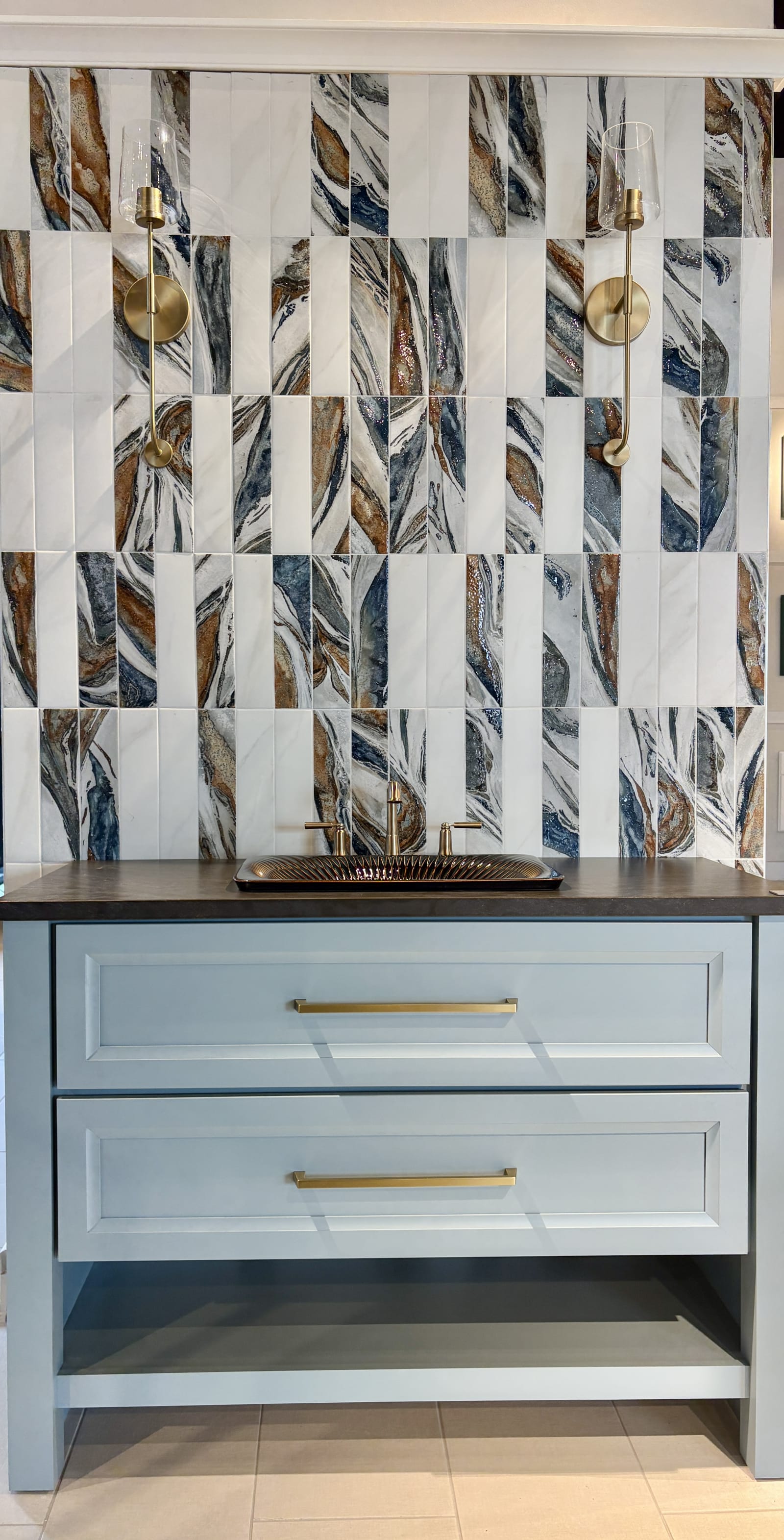 Deep blue painted kitchen cabinetry with brass hardware