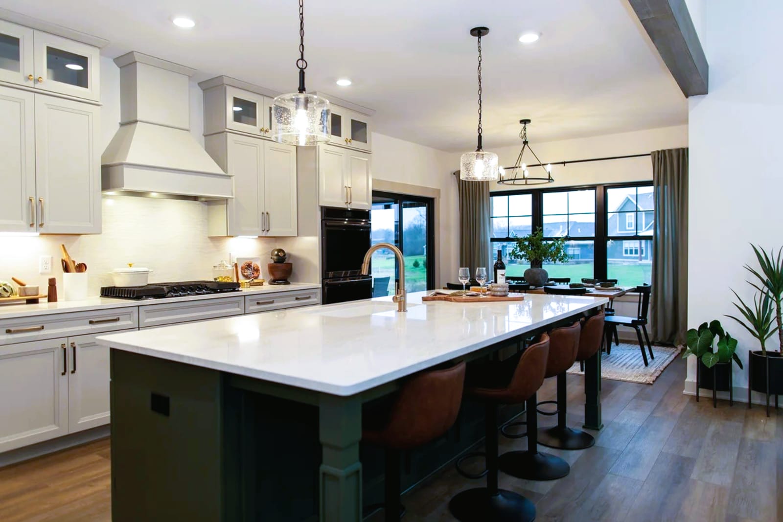 Kitchen cabinetry with brushed metal pulls and knobs